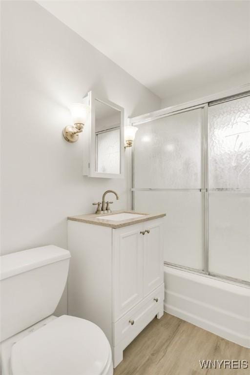 126 Pryor Ave, Tonawanda, NY 14150 - bathroom featuring vanity, wood finished floors, and bath / shower combo with glass door