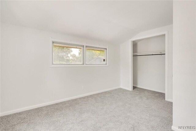 126 Pryor Ave, Tonawanda, NY 14150 - unfurnished bedroom with carpet flooring, a closet, and vaulted ceiling