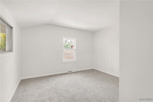 126 Pryor Ave, Tonawanda, NY 14150 - carpeted empty room with vaulted ceiling and baseboards
