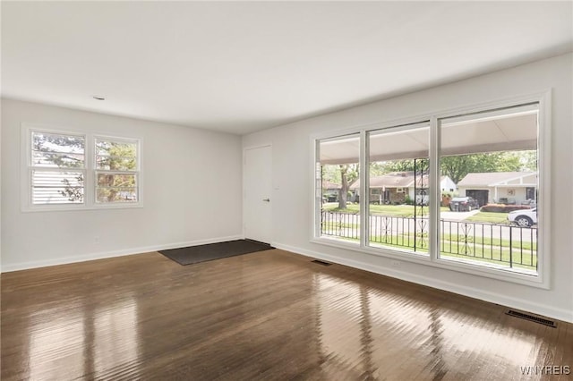 126 Pryor Ave, Tonawanda, NY 14150 - empty room with plenty of natural light and dark wood-style flooring