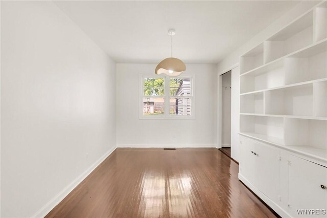 126 Pryor Ave, Tonawanda, NY 14150 - unfurnished dining area featuring dark wood finished floors and baseboards