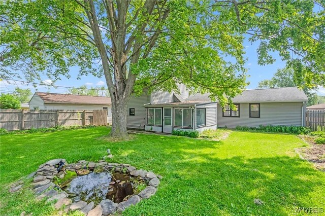 126 Pryor Ave, Tonawanda, NY 14150 - fenced yard featuring a sunroom