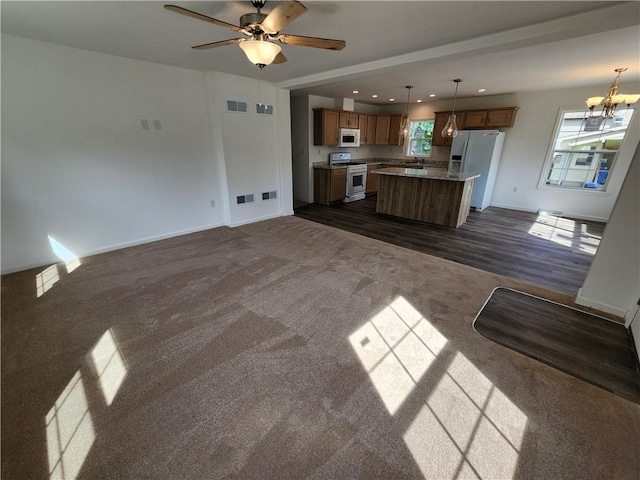 32 Jefferson St, North Dansville, NY 14437 - unfurnished living room featuring a chandelier, dark carpet, recessed lighting, and a ceiling fan