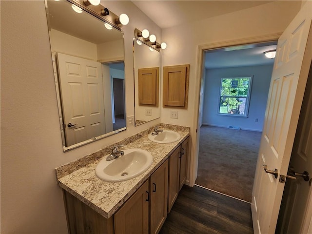 32 Jefferson St, North Dansville, NY 14437 - bathroom featuring double vanity and wood finished floors