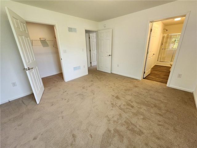 32 Jefferson St, North Dansville, NY 14437 - unfurnished bedroom with carpet floors, ensuite bath, a closet, and a spacious closet