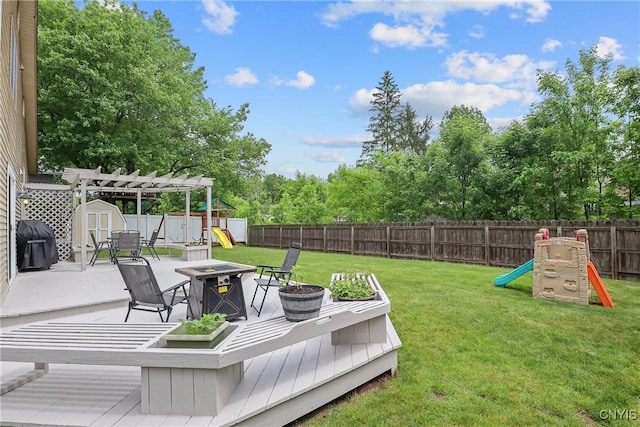 4330 Cinnamon Path, Clay, NY 13090 - fenced backyard featuring a playground, a fire pit, a shed, and a deck