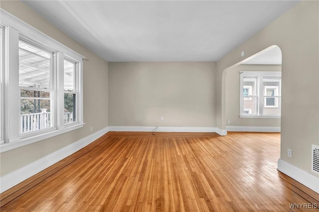 88 Rugby Rd, Buffalo, NY 14216 - empty room with plenty of natural light, light wood-style floors, and arched walkways