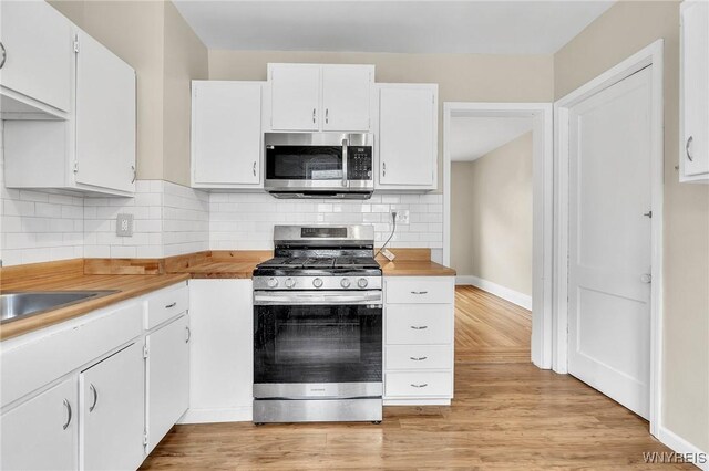 88 Rugby Rd, Buffalo, NY 14216 - kitchen with stainless steel appliances, white cabinets, and light wood-type flooring