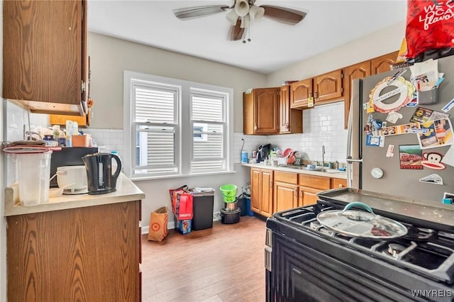 88 Rugby Rd, Buffalo, NY 14216 - kitchen featuring ceiling fan, backsplash, light countertops, and brown cabinets