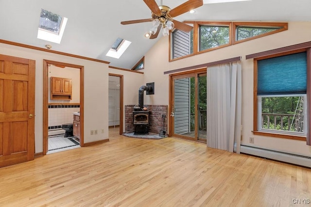 814 Oswego St, Salina, NY 13088 - unfurnished living room featuring a wood stove, baseboard heating, wood finished floors, a skylight, and high vaulted ceiling