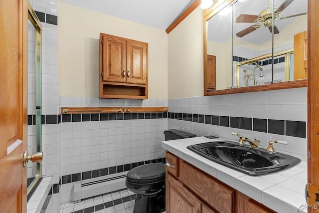 814 Oswego St, Salina, NY 13088 - bathroom with a tile shower, vanity, tile walls, baseboard heating, and a ceiling fan