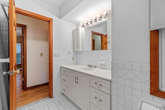 814 Oswego St, Salina, NY 13088 - bathroom with tile walls, vanity, tile patterned floors, and wainscoting