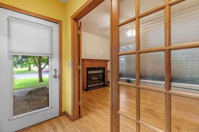 814 Oswego St, Salina, NY 13088 - doorway featuring light wood finished floors and a fireplace with flush hearth
