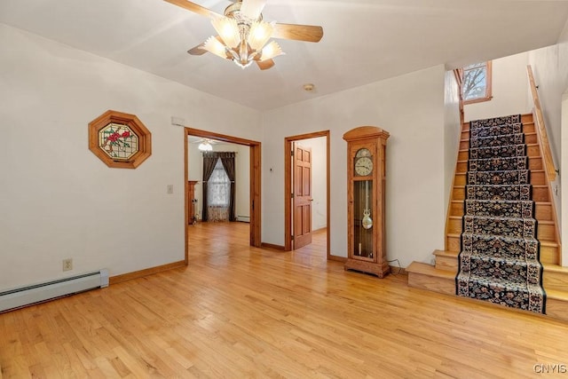 814 Oswego St, Salina, NY 13088 - unfurnished living room with ceiling fan, stairway, light wood finished floors, and a baseboard heating unit