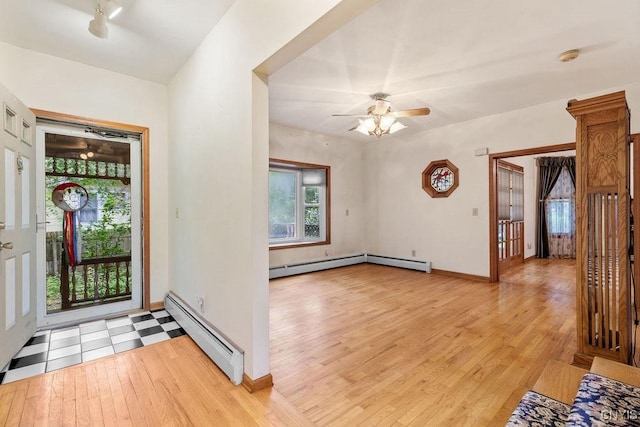 814 Oswego St, Salina, NY 13088 - entryway featuring baseboard heating, light wood finished floors, and ceiling fan