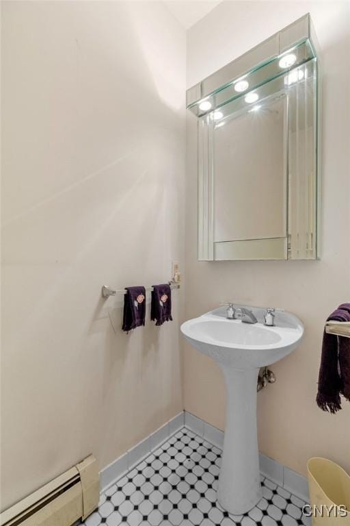 814 Oswego St, Salina, NY 13088 - bathroom featuring a baseboard heating unit and baseboards