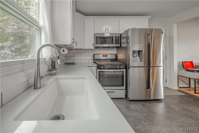 14 Euclid Ave, Lockport-City, NY 14094 - kitchen with stainless steel appliances, white cabinetry, light countertops, and backsplash