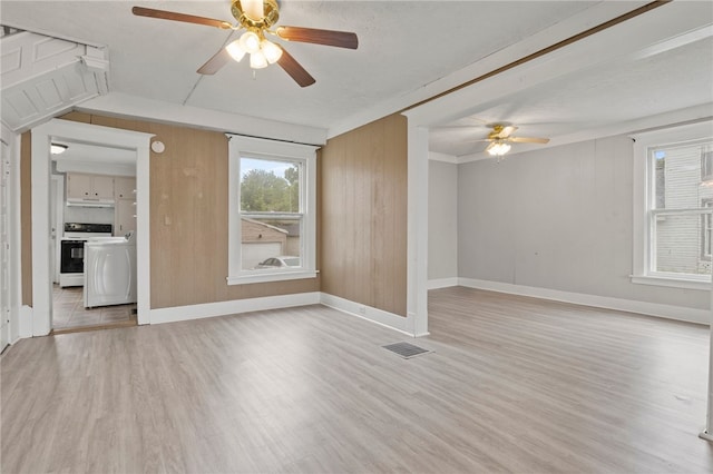 328 W Main St, Palmyra, NY 14522 - unfurnished living room with a ceiling fan, light wood-style floors, and washer / clothes dryer
