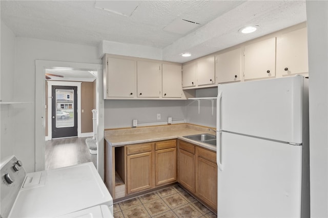 328 W Main St, Palmyra, NY 14522 - kitchen with freestanding refrigerator, washer and clothes dryer, light countertops, a textured ceiling, and recessed lighting