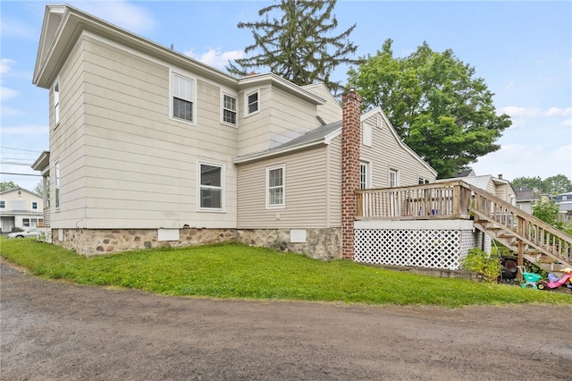328 W Main St, Palmyra, NY 14522 - view of side of home featuring a deck, a chimney, stairs, and a lawn