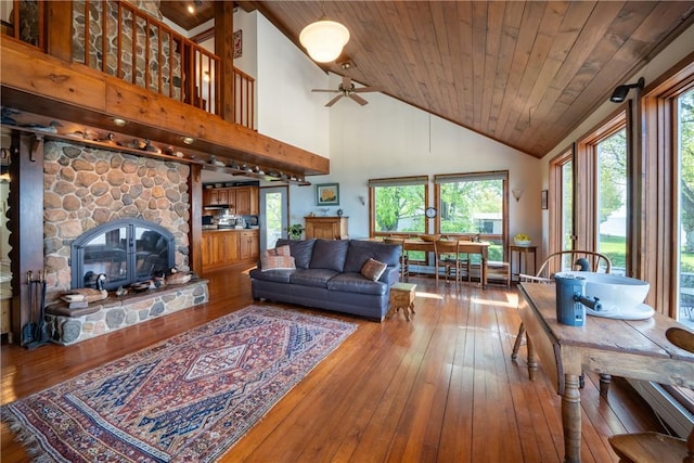 11037 Pratt Ln Unit 21, Yates, NY 14098 - living area featuring wood-type flooring, wooden ceiling, a stone fireplace, high vaulted ceiling, and ceiling fan