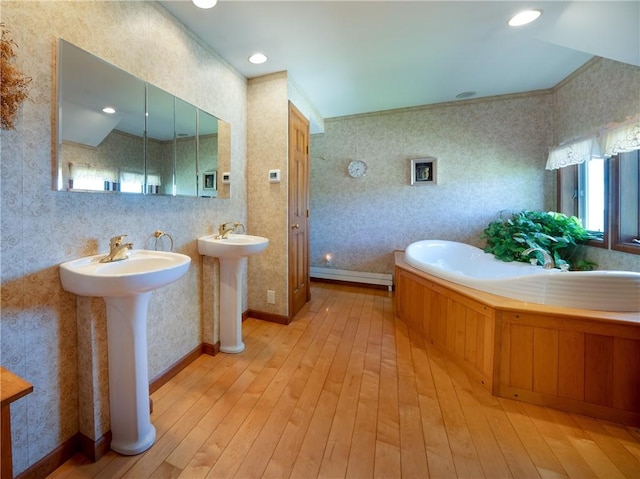11037 Pratt Ln Unit 21, Yates, NY 14098 - full bathroom featuring wallpapered walls, hardwood / wood-style flooring, a bath, two sinks, and a baseboard heating unit