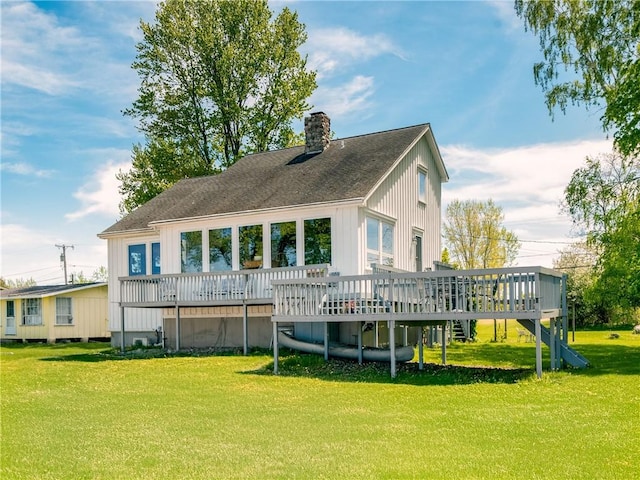 11037 Pratt Ln Unit 21, Yates, NY 14098 - rear view of house featuring a wooden deck, a lawn, a chimney, and a shingled roof