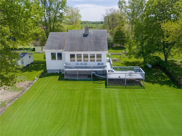 11037 Pratt Ln Unit 21, Yates, NY 14098 - rear view of property with a yard, a chimney, a deck, and roof with shingles