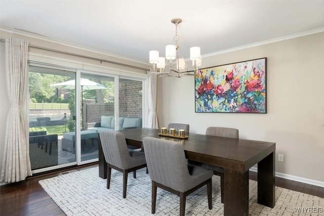 61 Hidden Ridge Cmn, Amherst, NY 14221 - dining area featuring a chandelier, crown molding, and wood finished floors
