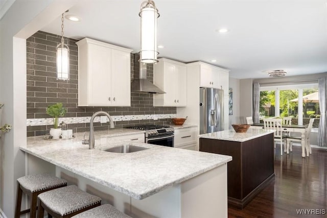 61 Hidden Ridge Cmn, Amherst, NY 14221 - kitchen featuring appliances with stainless steel finishes, extractor fan, a center island, tasteful backsplash, and recessed lighting