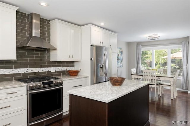 61 Hidden Ridge Cmn, Amherst, NY 14221 - kitchen with wall chimney range hood, stainless steel appliances, dark wood-type flooring, tasteful backsplash, and recessed lighting