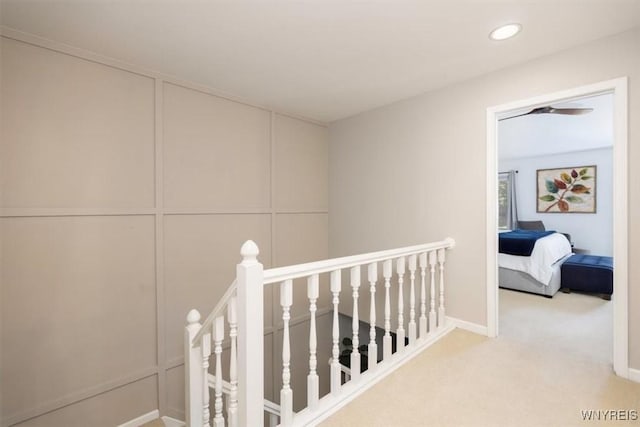 61 Hidden Ridge Cmn, Amherst, NY 14221 - corridor featuring an upstairs landing, carpet floors, recessed lighting, and a decorative wall