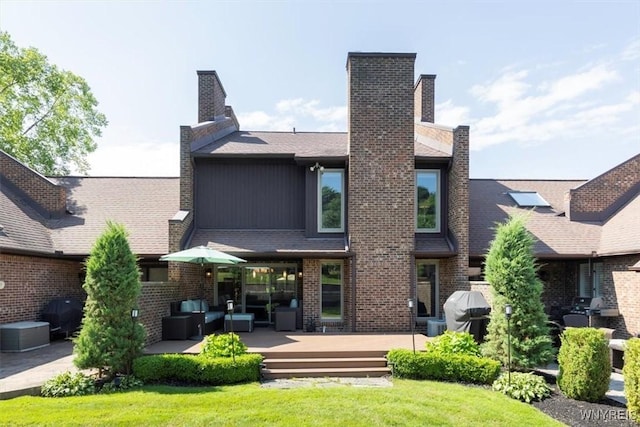 61 Hidden Ridge Cmn, Amherst, NY 14221 - back of property featuring a wooden deck, a yard, outdoor lounge area, and brick siding