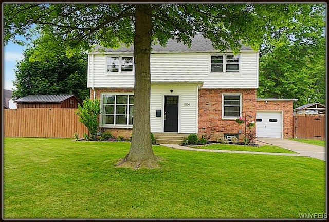 1104 Cayuga Dr, Niagara Falls, NY 14304 - colonial-style house featuring brick siding, driveway, and an attached garage