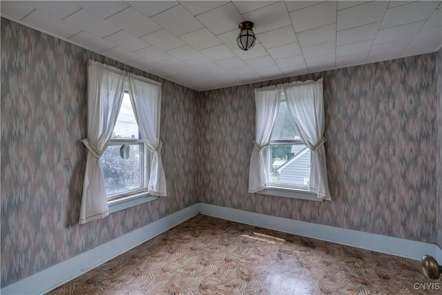 9569 Church St, Denmark, NY 13620 - spare room with healthy amount of natural light and wallpapered walls