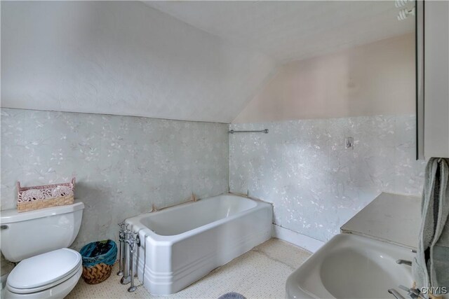 9569 Church St, Denmark, NY 13620 - bathroom with lofted ceiling and a bath