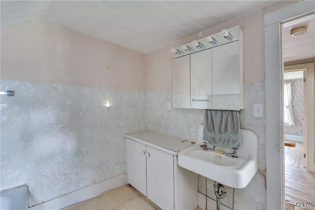 9569 Church St, Denmark, NY 13620 - bathroom featuring wainscoting, vaulted ceiling, and tile walls