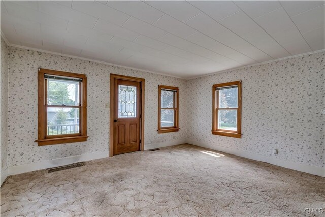 9569 Church St, Denmark, NY 13620 - carpeted foyer with plenty of natural light, ornamental molding, and wallpapered walls