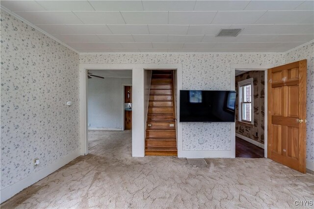 9569 Church St, Denmark, NY 13620 - carpeted spare room featuring wallpapered walls, crown molding, and stairway