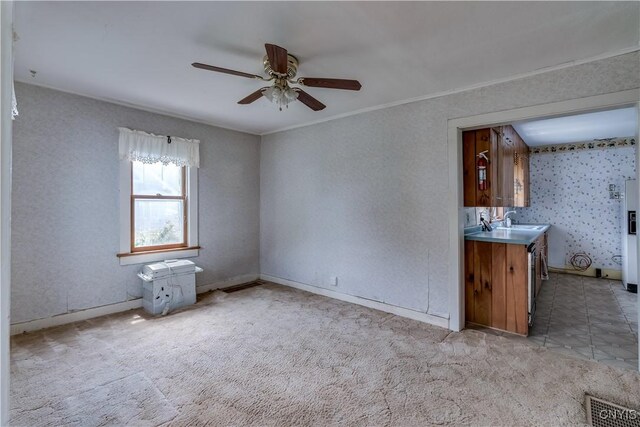 9569 Church St, Denmark, NY 13620 - unfurnished living room with a ceiling fan, carpet floors, and crown molding