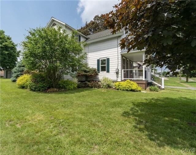 9569 Church St, Denmark, NY 13620 - view of home's exterior with a yard and covered porch
