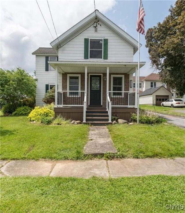 9569 Church St, Denmark, NY 13620 - bungalow with covered porch and a front lawn