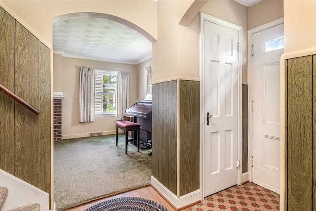 61 Avondale Rd, Irondequoit, NY 14622 - carpeted entryway featuring arched walkways, ornamental molding, and stairway