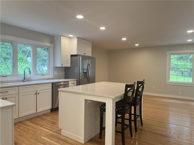 43 Harvest Rd, Perinton, NY 14450 - kitchen with stainless steel appliances, light wood-style floors, light countertops, white cabinets, and recessed lighting