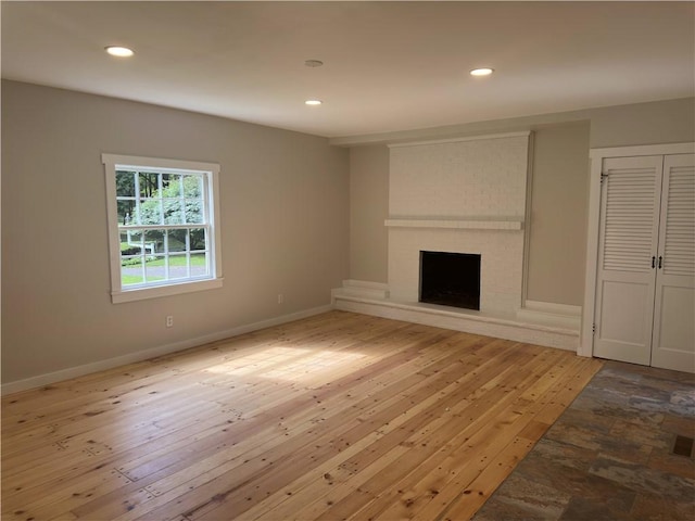 43 Harvest Rd, Perinton, NY 14450 - unfurnished living room with a fireplace, recessed lighting, and light wood-style flooring