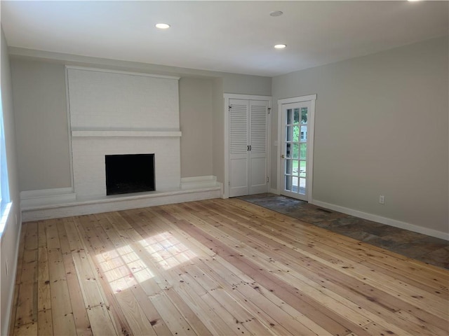 43 Harvest Rd, Perinton, NY 14450 - unfurnished living room featuring hardwood / wood-style floors, a brick fireplace, and recessed lighting