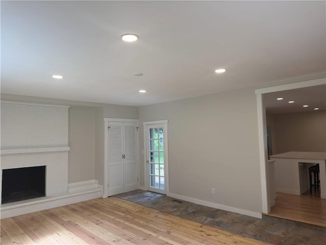 43 Harvest Rd, Perinton, NY 14450 - unfurnished living room with hardwood / wood-style floors, a fireplace, and recessed lighting