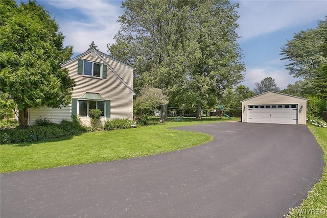 265 Miller Rd, Amherst, NY 14068 - view of side of home featuring a detached garage, a yard, an outdoor structure, and a playground