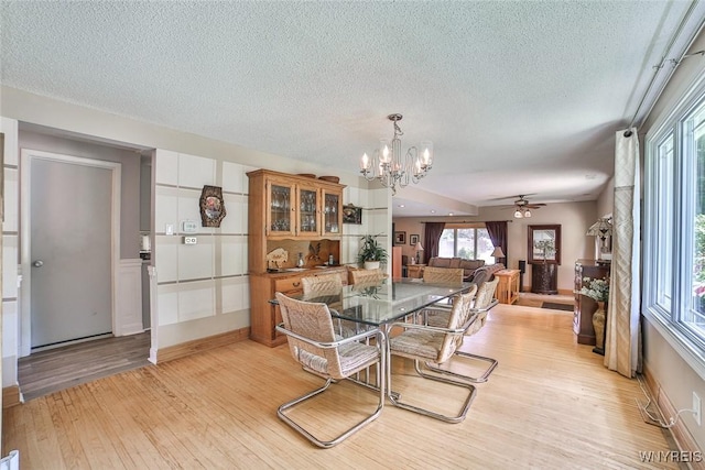 265 Miller Rd, Amherst, NY 14068 - dining area with light wood-type flooring, a chandelier, a textured ceiling, and ceiling fan
