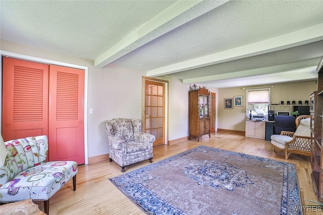 265 Miller Rd, Amherst, NY 14068 - living area with wood finished floors, beamed ceiling, and a textured ceiling